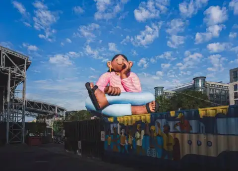 AN INDONESIAN ARTIST JUST PUT A 20-FOOT DAYDREAMER ON A BRUSSELS CANAL, AND BELGIUM CAN'T STOP LOOKING 